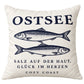 Naturfarbene Cozy Coast Kissenhülle OSTSEE 50 x 50 cm mit dunkelblauen Fischen und dem Spruch „Salz auf der Haut, Glück im Herzen“