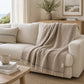 Decke PROFLAX Italian Wool Mix Stone auf Sofa im Coastal Look